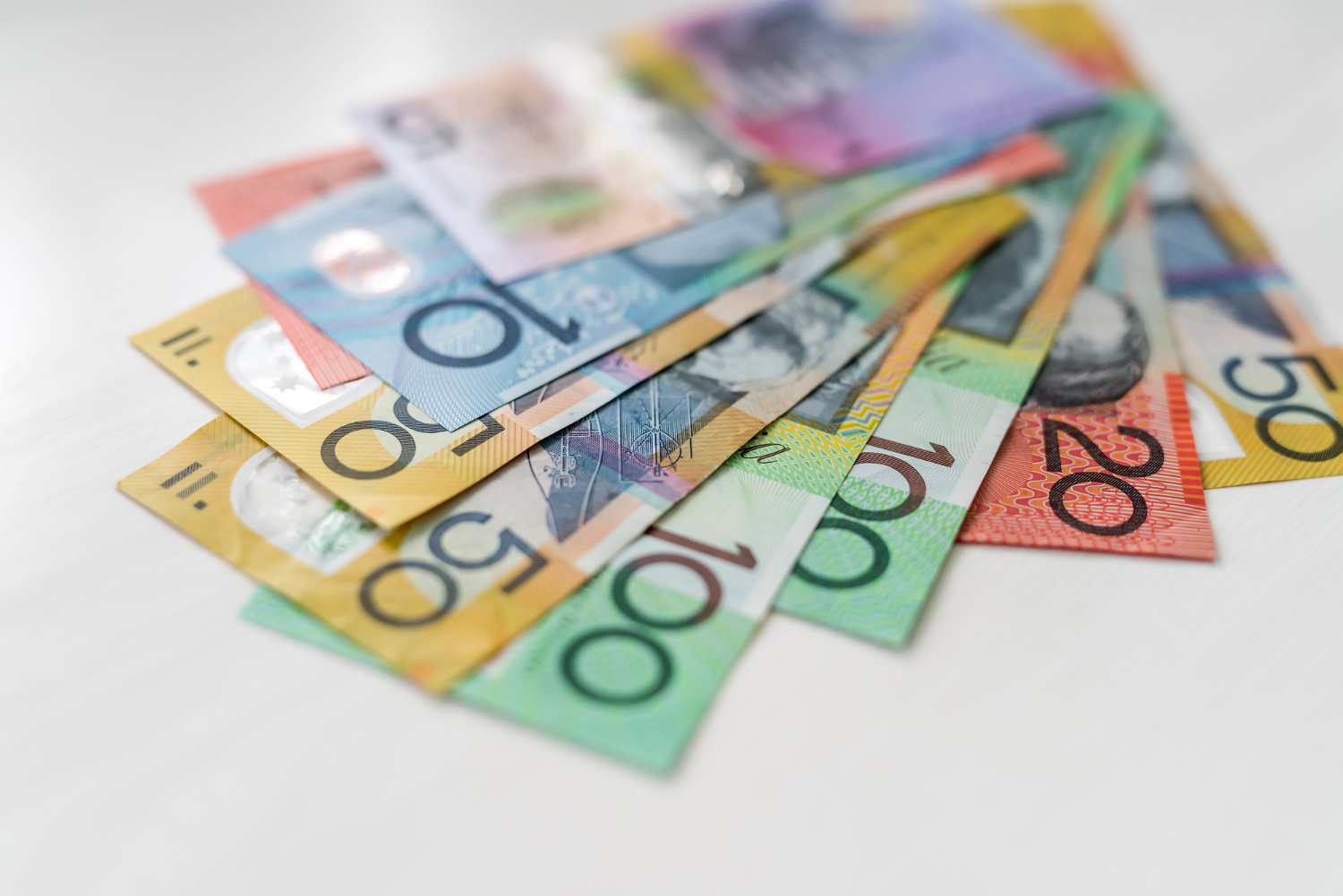colorful australian dollars laying wooden table